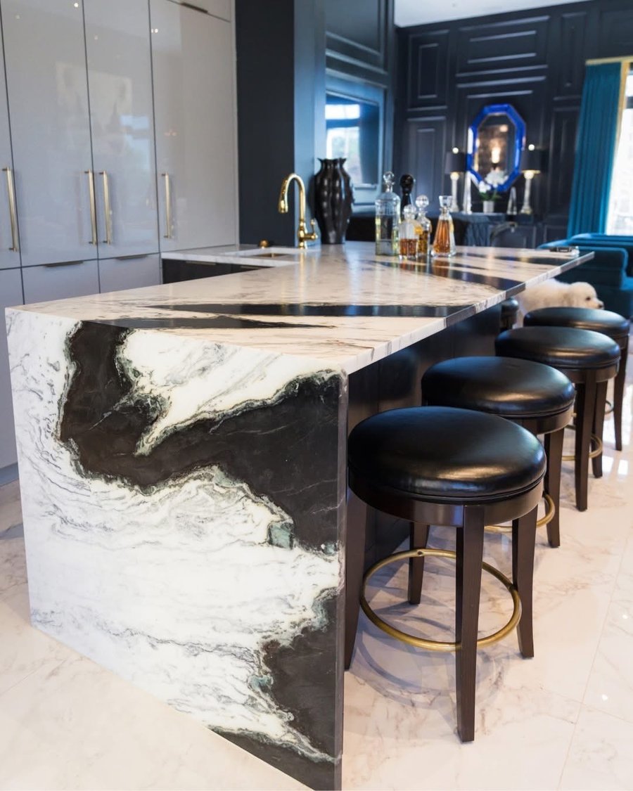 Marble waterfall kitchen island fabricated by Gaumats International